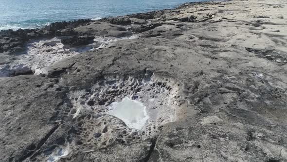 Drone flying low, over volcanic rock on Ko Olina Shore, Beautiful crystal clear sea, Hawaii