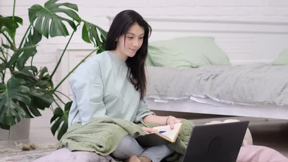 Teenage Girl Doing Homework on the Floor