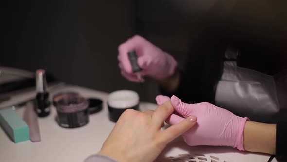 Closeup of Nail Master Makes Professional Manicure To Woman in Nail Care Salon