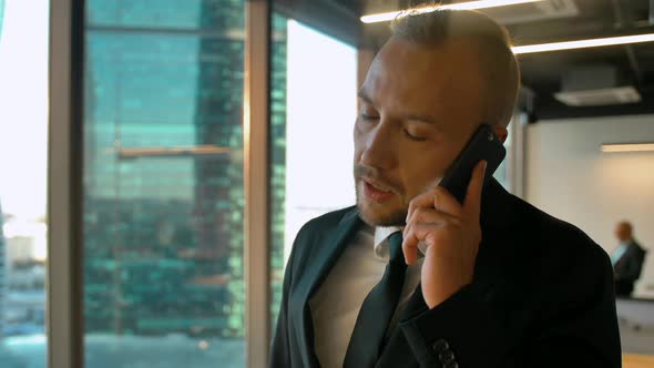 Portrait of Businessman in Coworking Office Calling To His Deal Partner