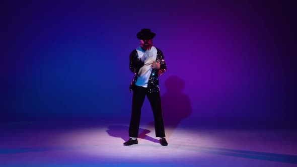 Young Stylish Man Dancing, Spotlight on a Background.Young Stylish Man Dancing in Style Michael Jackson, Spotlight on a Blue Background.