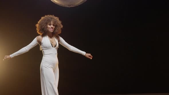 Charming African American Woman Wearing Roller Skates Rides Around on the Stage