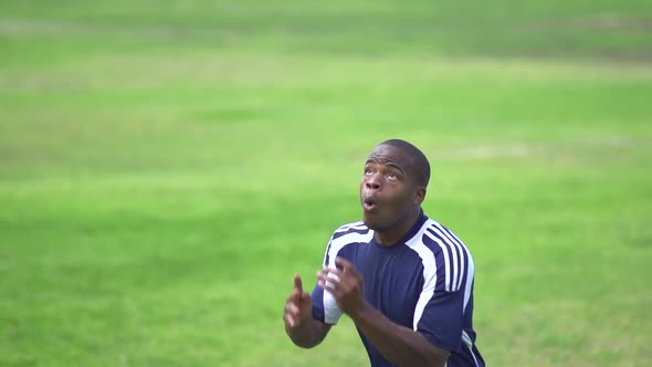 A man playing soccer on a grassy field