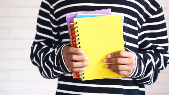 Teenage Boy Holing Colorful Notepad