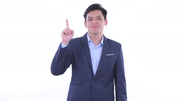 Happy Young Asian Businessman Pointing Up