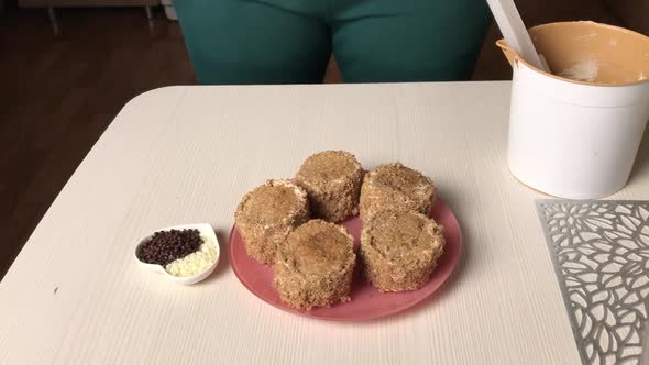 A Woman Makes A Sponge Cake With Butter Cream And Biscuit Crumbs.