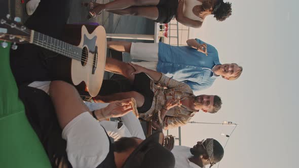 Vertical Shot of People Hanging Out on Rooftop Terrace