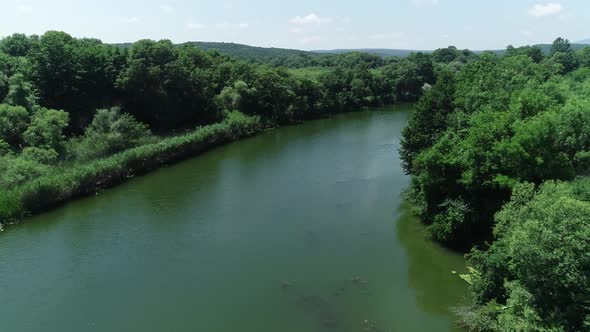 Aerial view of river and beautiful wild forest.