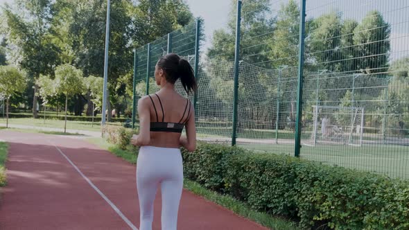 African Athletic Woman Running in the City Park