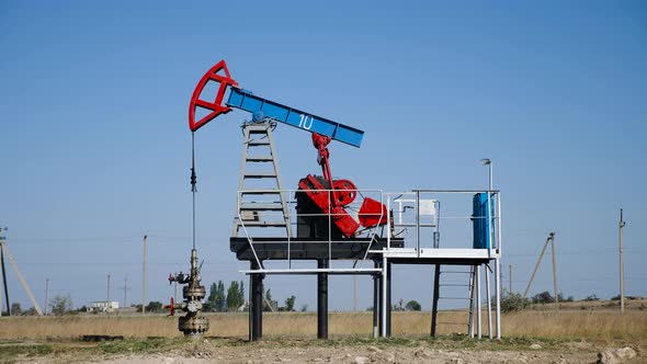 Oil Rig Stands in a Field at and Extracts Minerals