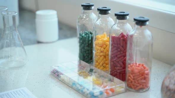 Random Name Variety of Drugs, Document and Flasks Are on Table in Chemical Pharmaceutical Laboratory