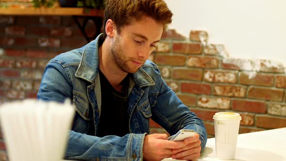Man using mobile phone at table