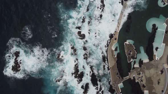 A top down view of the rough waves in Porto Moniz, Madeira. Shot on DJI.
