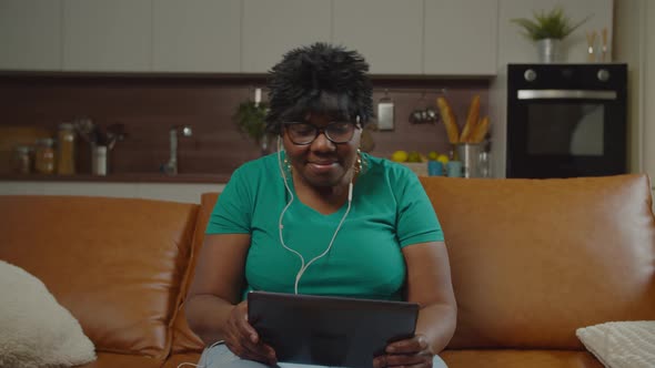 Mature Black Female Listening To Music with Tablet Pc