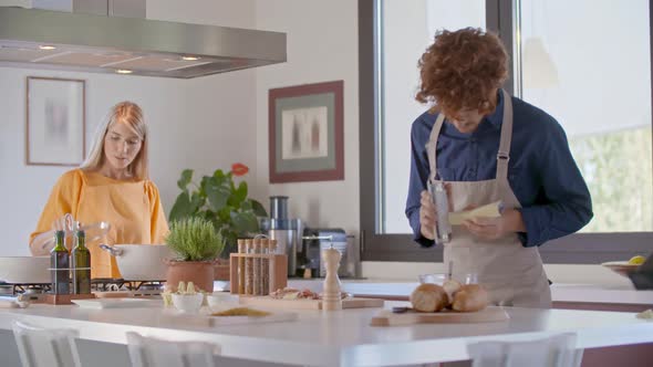 Woman Cooking and Checking Meal in Modern Kitchen