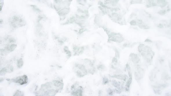 Sea Waves Roll on Pebbles Shore During a Light Storm Close Up Top View Slow Motion Slow Motion