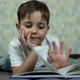 Little Boy Lying on the Bed and Reading a Book. - VideoHive Item for Sale