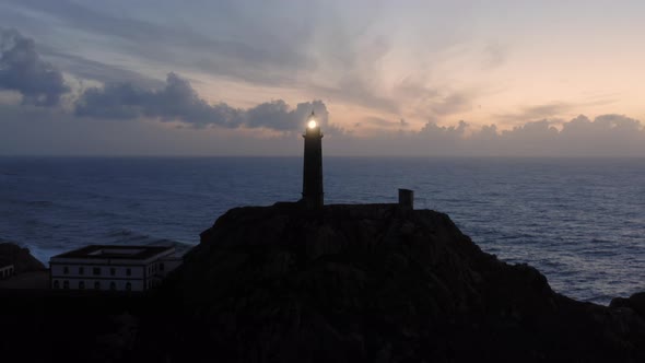 Lit Lighthouse at Dusk in Cape Vilan Galicia Spain Aerial View