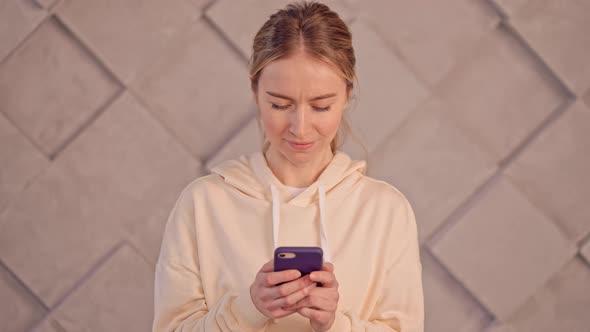 Young Female Typing Message on Mobile