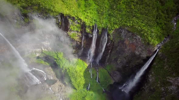 Aerial view of waterfalls and people canyoneering in Reunion island.