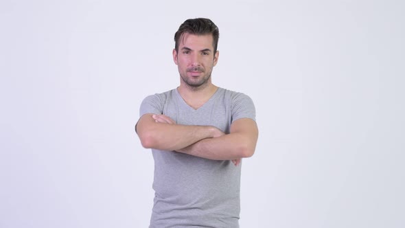 Young Happy Hispanic Man Smiling with Arms Crossed