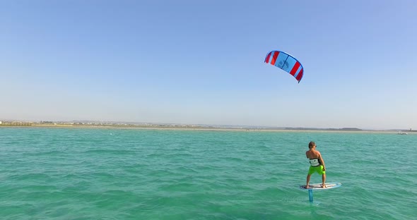 A man kiteboarding on a hydrofoil kite board