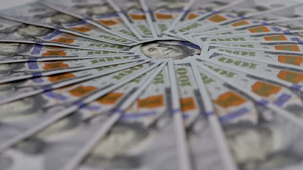 A Lot of Hundreddollar Bills are Lying Around and Slowly Rotating