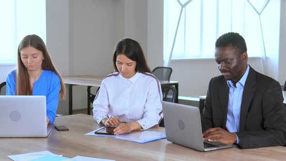 Diverse Employees Sitting at the Workplace Staff Celebrate Great Deal