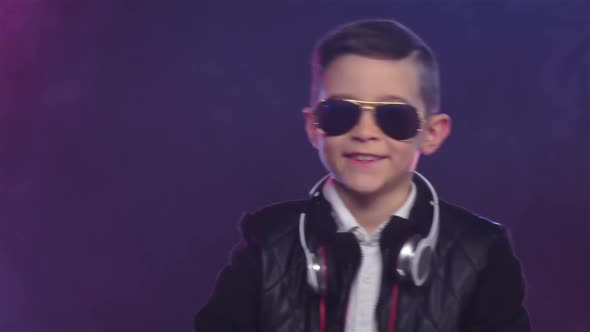 Boy in Stylish Glasses Dances on Colored Smoky, Slow Motion