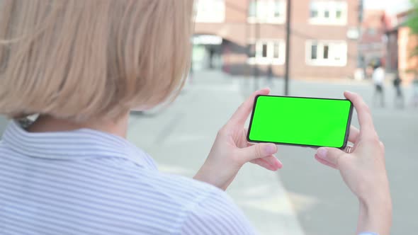 Woman Using Smartphone with Green Chroma Screen