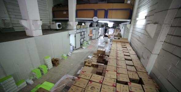 Man Carrying Boxes In Storage Room