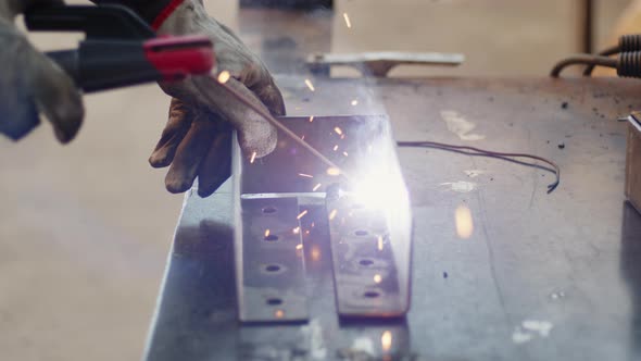 Welding Expert Man at Work on Iron