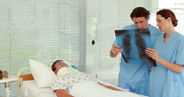 Doctors looking at patient Xray