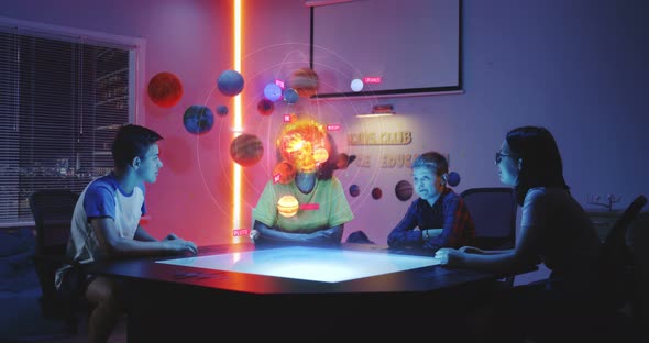 Teacher and Students Looking at Solar System Hologram