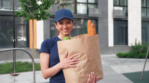 Portrait Smiling Food Delivery Woman Courier Holds Paper Bag with Groceries