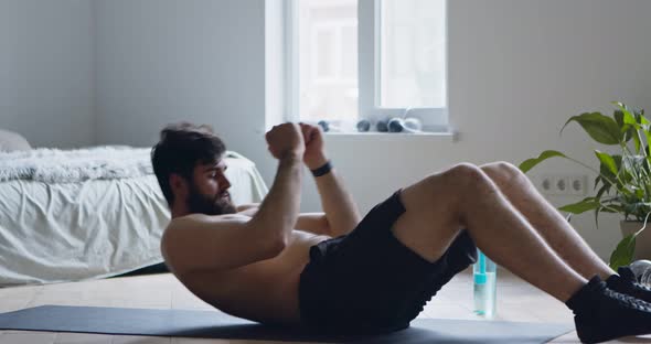 Young Man Doing Abdominal Exercise, Practicing Crunches