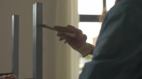 Woman Painting Old Wooden Table or Chair in Grey