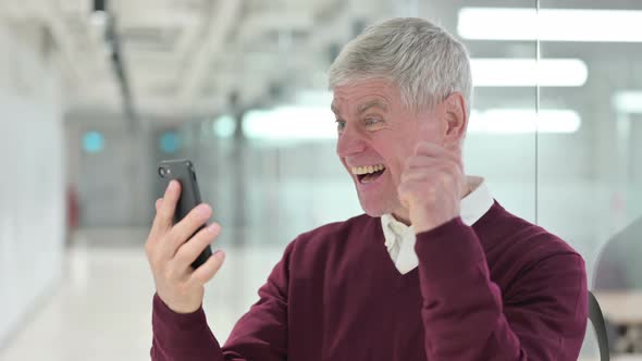 Middle Aged Man Celebrating on Smartphone 