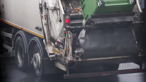 Municipal Recycling Garbage Collector Truck Loading Waste Into the Garbage Truck