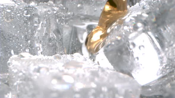 Macro Of Ice Cubes With Whiskey Pouring In Slow Motion 