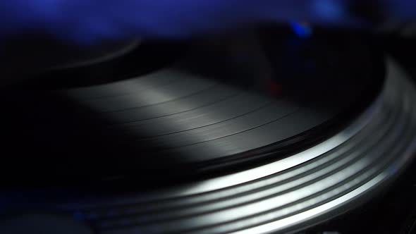 Hand of DJ on Vinyl and Gramophone Scratching Record Nightclub Party in 1980s