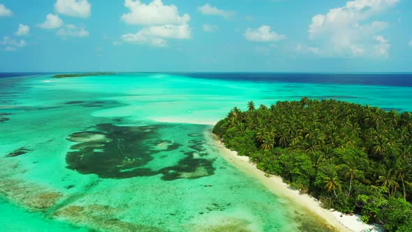 Aerial drone shot scenery of luxury sea view beach break by aqua blue lagoon with bright sandy backg