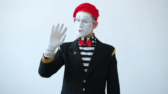 Friendly Mime Artist Waving Hand Saying Hello Greeting People and Looking at Camera