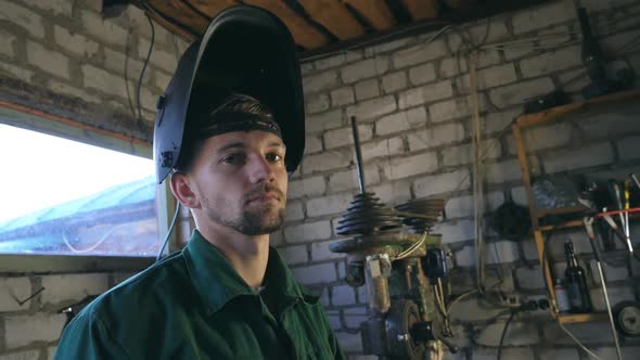 Tired Mechanic Looking at Camera