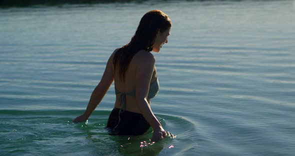 Woman walking in water at beach 