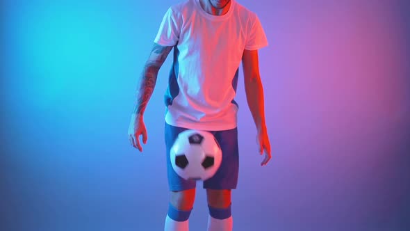 Profile View of Professional Soccer Player in Team Uniform Juggling Ball with His Legs, Slow Motion