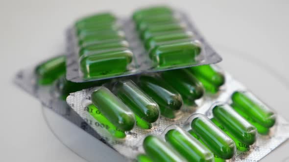 Rotating view of green tablets packets, Green tablets view