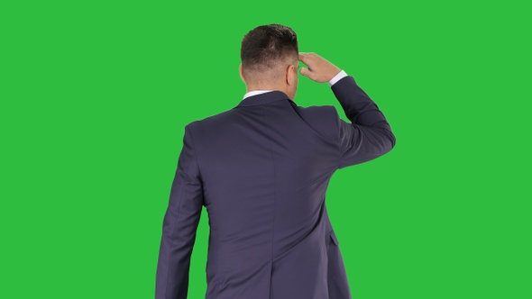 Businessman walking and looking far away on a Green Screen