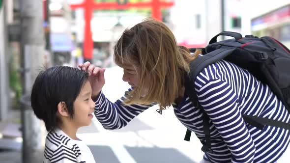 Asian Mother Talking With Her Son While Travel In Japan