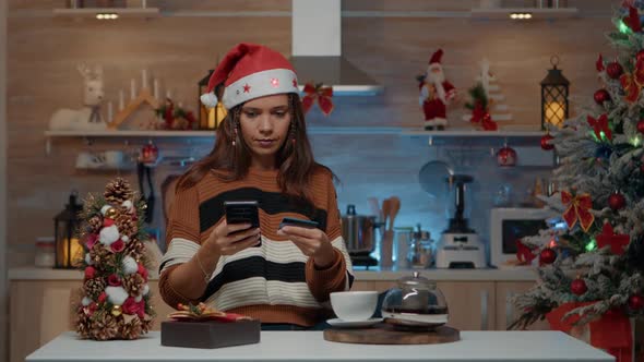 Festive Adult Using Smartphone for Online Shopping